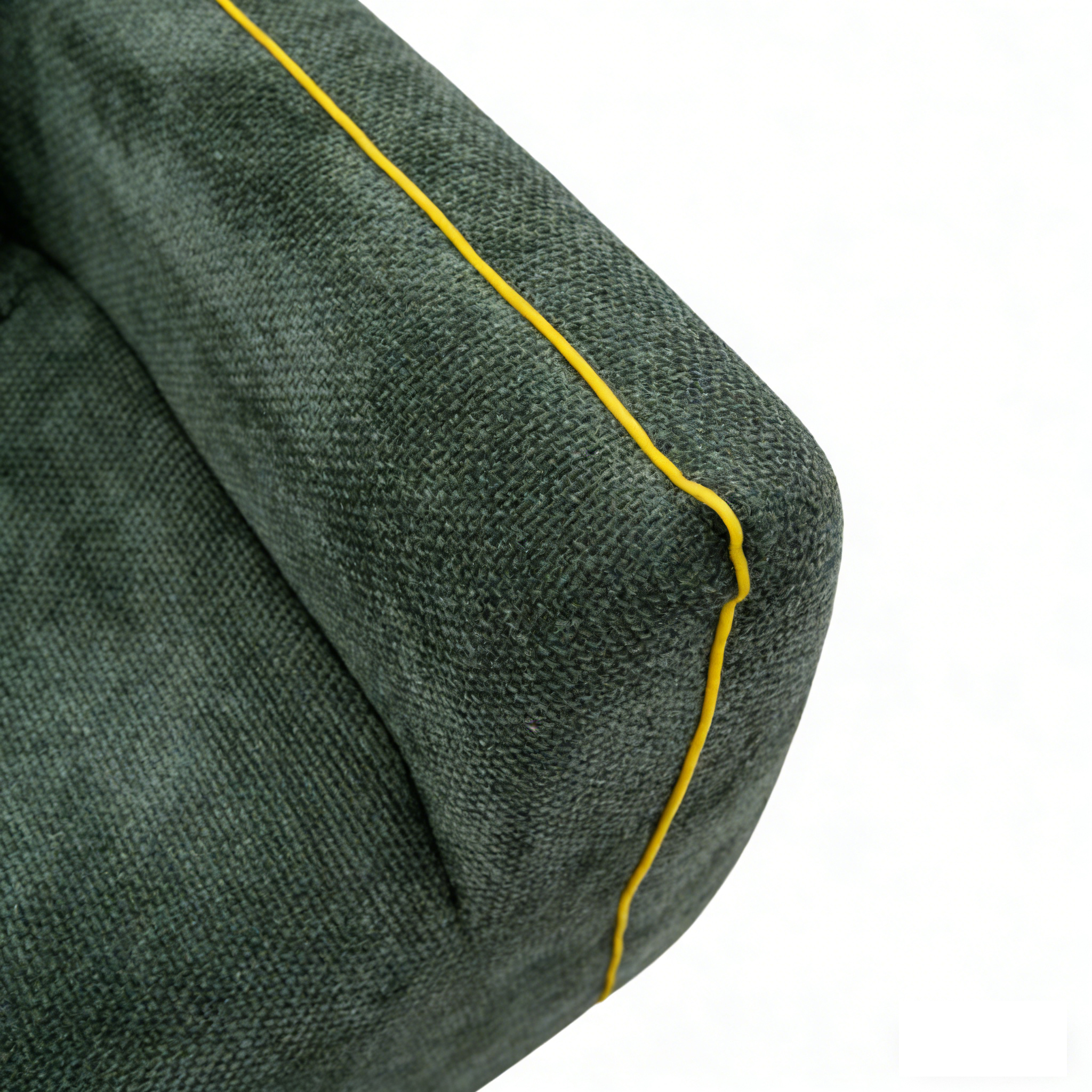 Close-up of durable textured fabric and yellow piping detail on a soft foam armchair